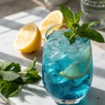 Glass of homemade blue salt recipe with lemon and mint for hydration